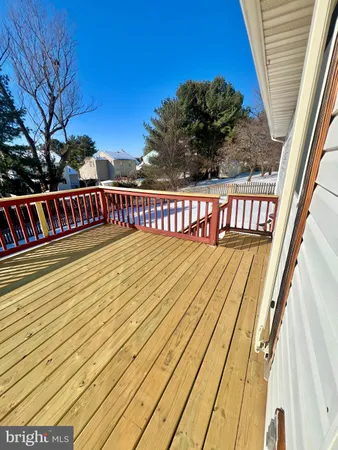a view of balcony with wooden floor and fence