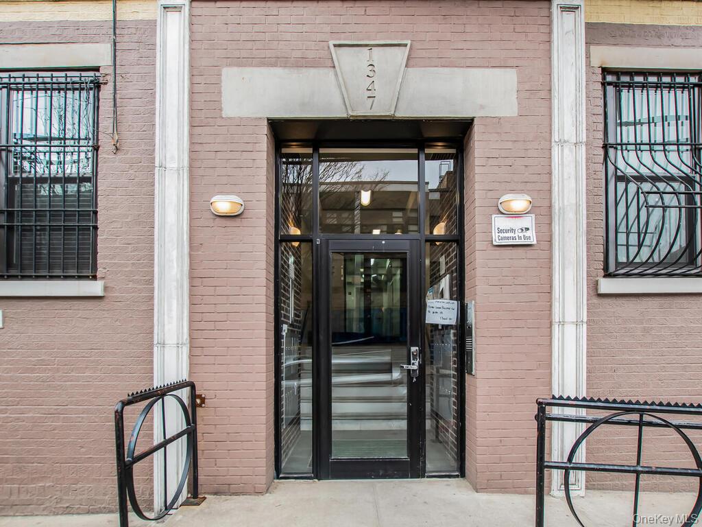 a view of entryway with a front door and wooden floor