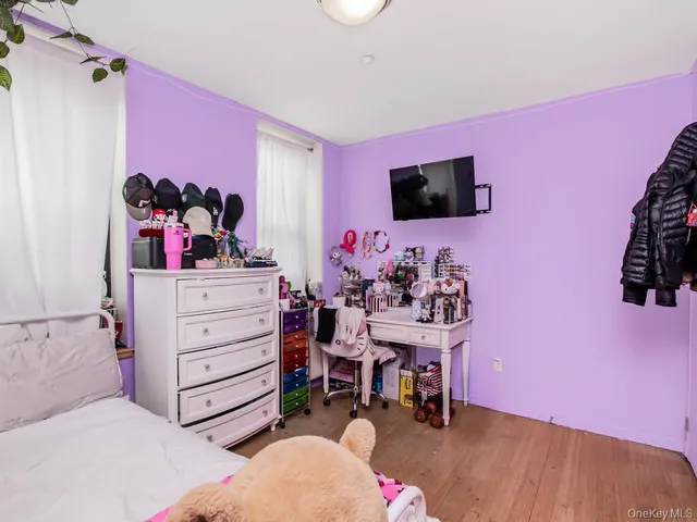 a bed room with a bed and a flat screen tv