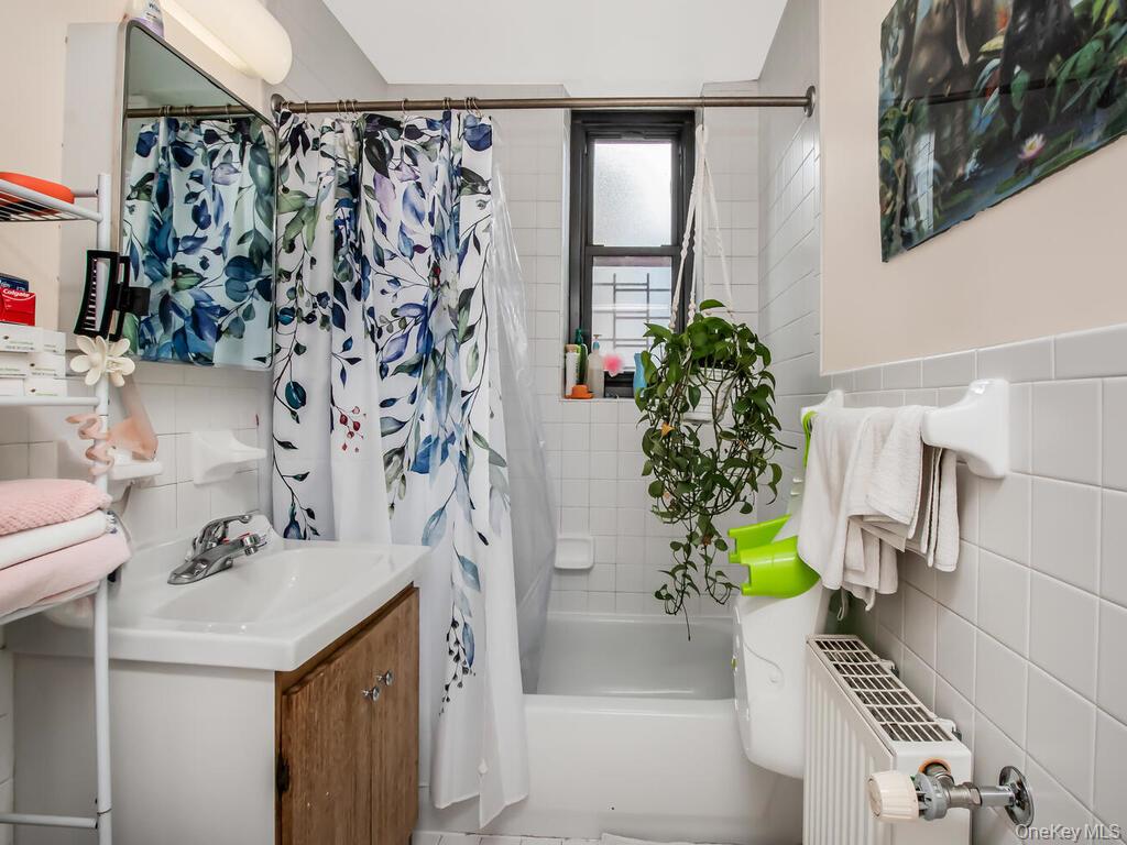 1347 Bristow Street, Unit 4B Bronx, NY 10459 - Photo 8 of 12 a bathroom with a sink a toilet and shower