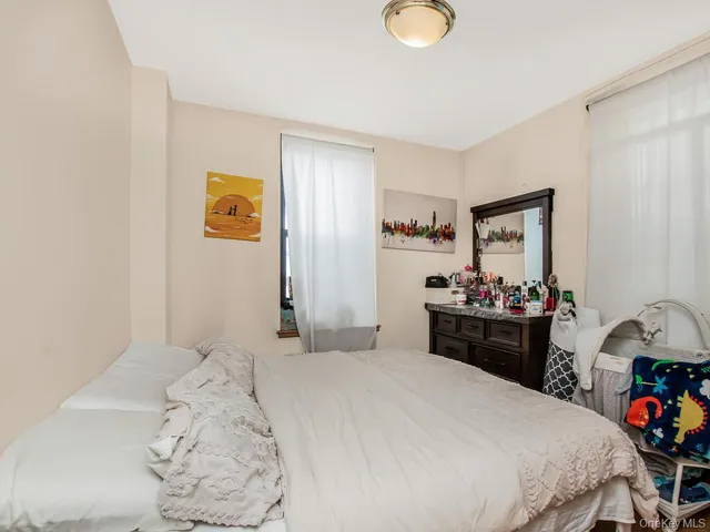 a bedroom with a bed and a dresser in it