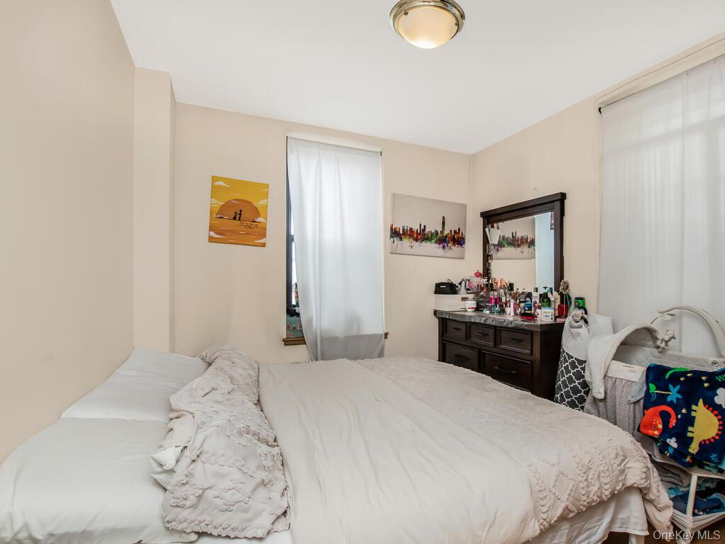 1347 Bristow Street, Unit 4B Bronx, NY 10459 - Photo 9 of 12 a bedroom with a bed and a dresser in it