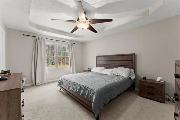 a bedroom with a bed and ceiling fan