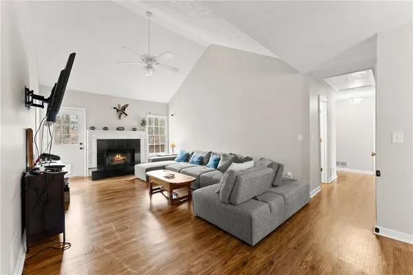 a living room with furniture a fireplace and a flat screen tv
