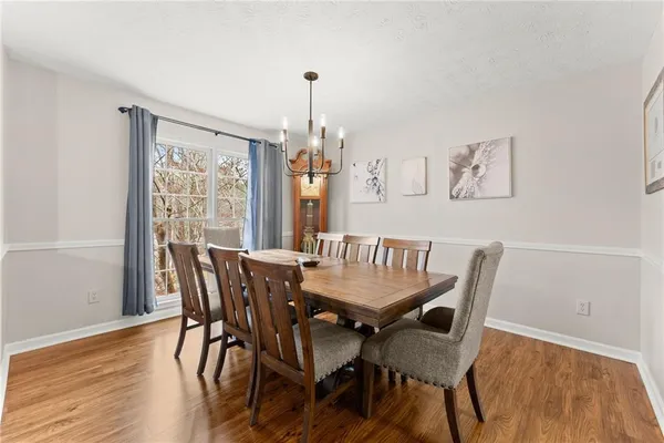 a view of a dining room with furniture window and wooden floor