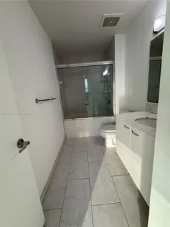a bathroom with a sink a toilet and mirror