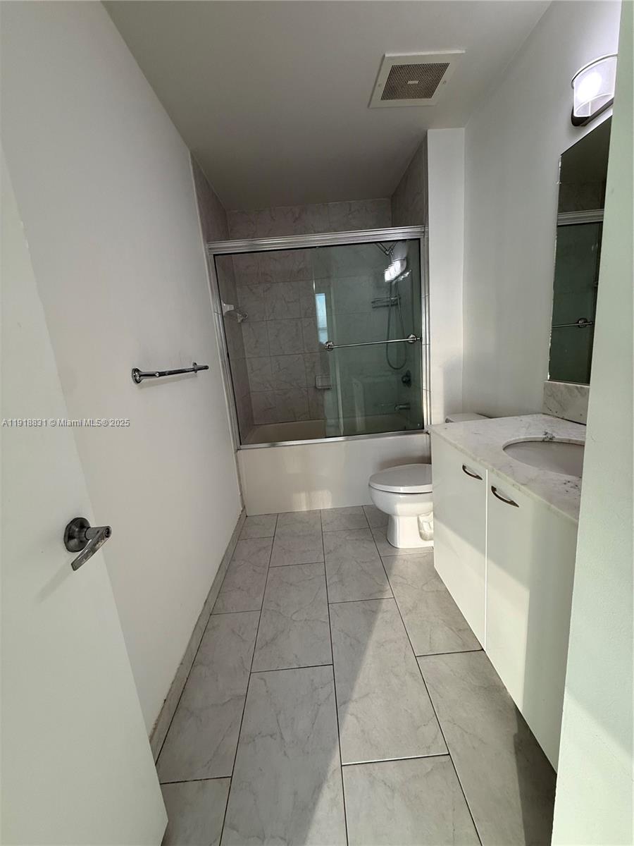 133 Northeast 2nd Avenue, Unit 2912 Miami, FL 33132 - Photo 11 of 30 a bathroom with a sink a toilet and mirror