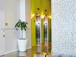 a room with pool table and windows