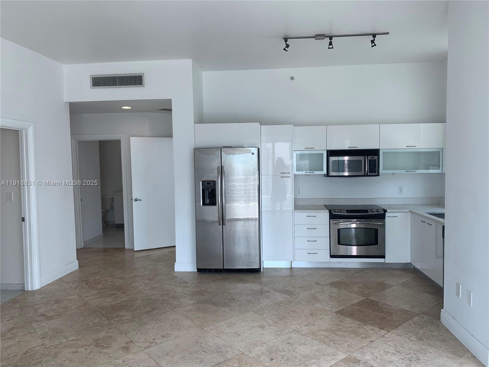 133 Northeast 2nd Avenue, Unit 2912 Miami, FL 33132 - Photo 5 of 30 a view of a kitchen with an oven and refrigerator