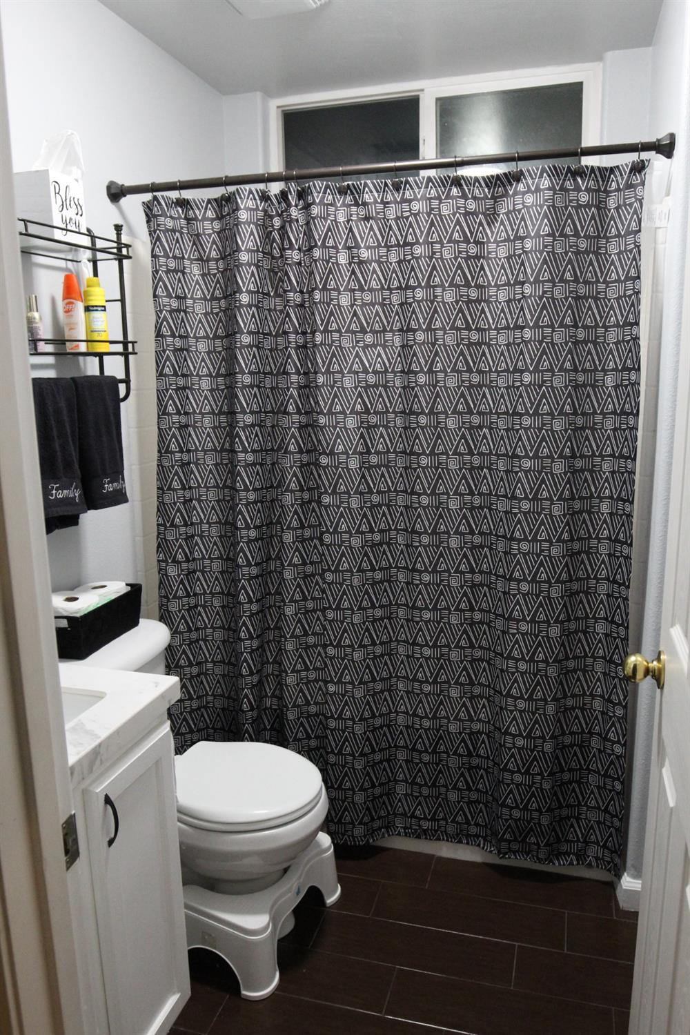 2653 Ashcroft Avenue Clovis, CA 93611 - Photo 13 of 45 a bathroom with a toilet and a shower