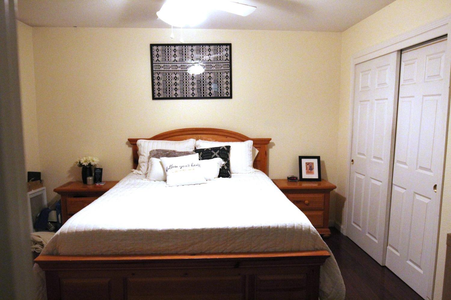 2653 Ashcroft Avenue Clovis, CA 93611 - Photo 17 of 45 a bedroom with a bed and wooden floor