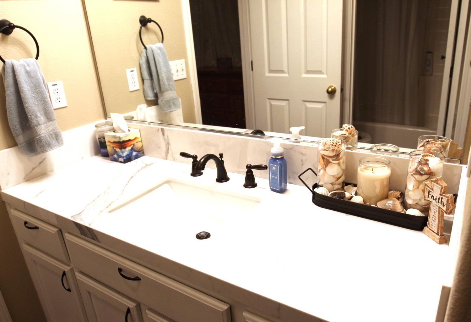 2653 Ashcroft Avenue Clovis, CA 93611 - Photo 18 of 45 a bathroom with a sink and a mirror