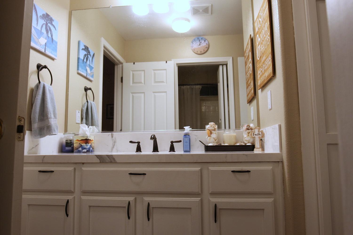 2653 Ashcroft Avenue Clovis, CA 93611 - Photo 19 of 45 a bathroom with a double vanity sink and a mirror