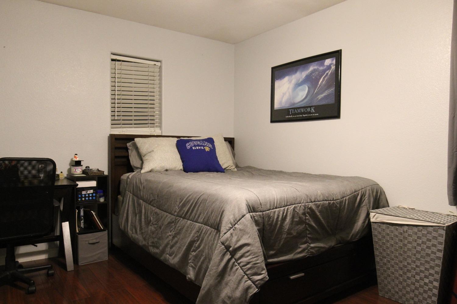 2653 Ashcroft Avenue Clovis, CA 93611 - Photo 21 of 45 a bedroom with a bed and wooden floor