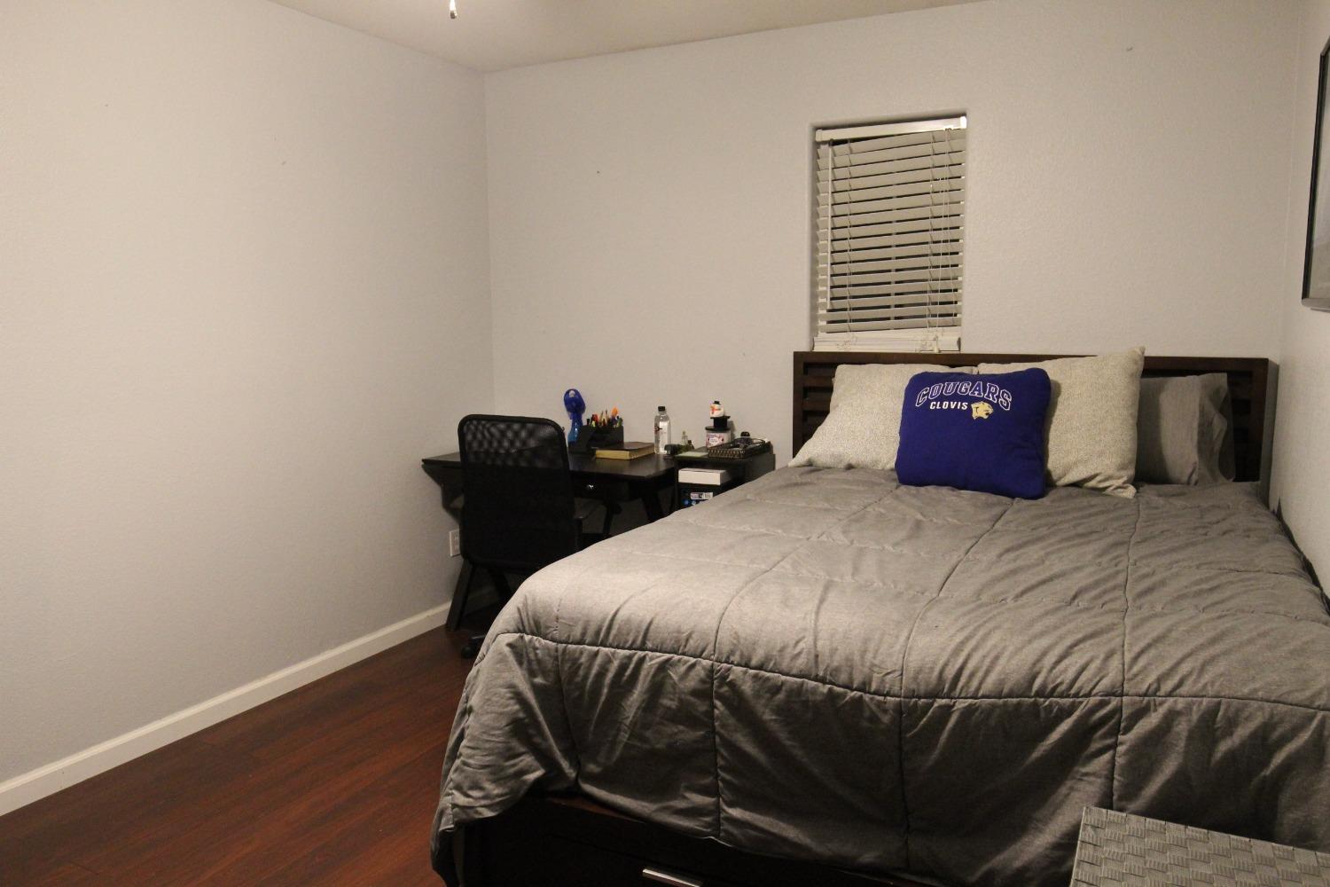 2653 Ashcroft Avenue Clovis, CA 93611 - Photo 22 of 45 a bedroom with a bed and wooden floor