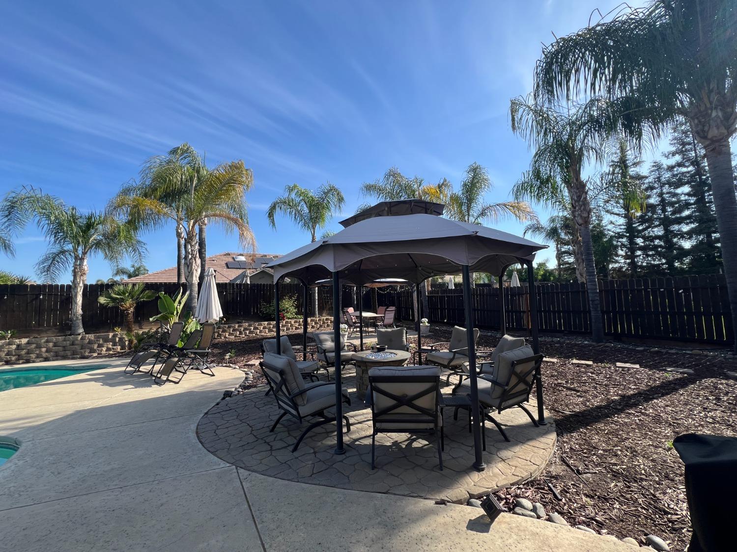 2653 Ashcroft Avenue Clovis, CA 93611 - Photo 33 of 45 a view of a tables and chairs under an umbrella in patio