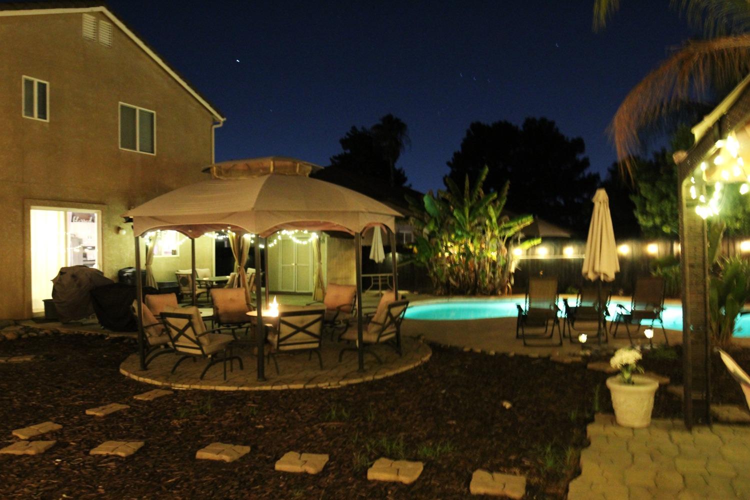 2653 Ashcroft Avenue Clovis, CA 93611 - Photo 34 of 45 a view of a patio with table and chairs potted plants