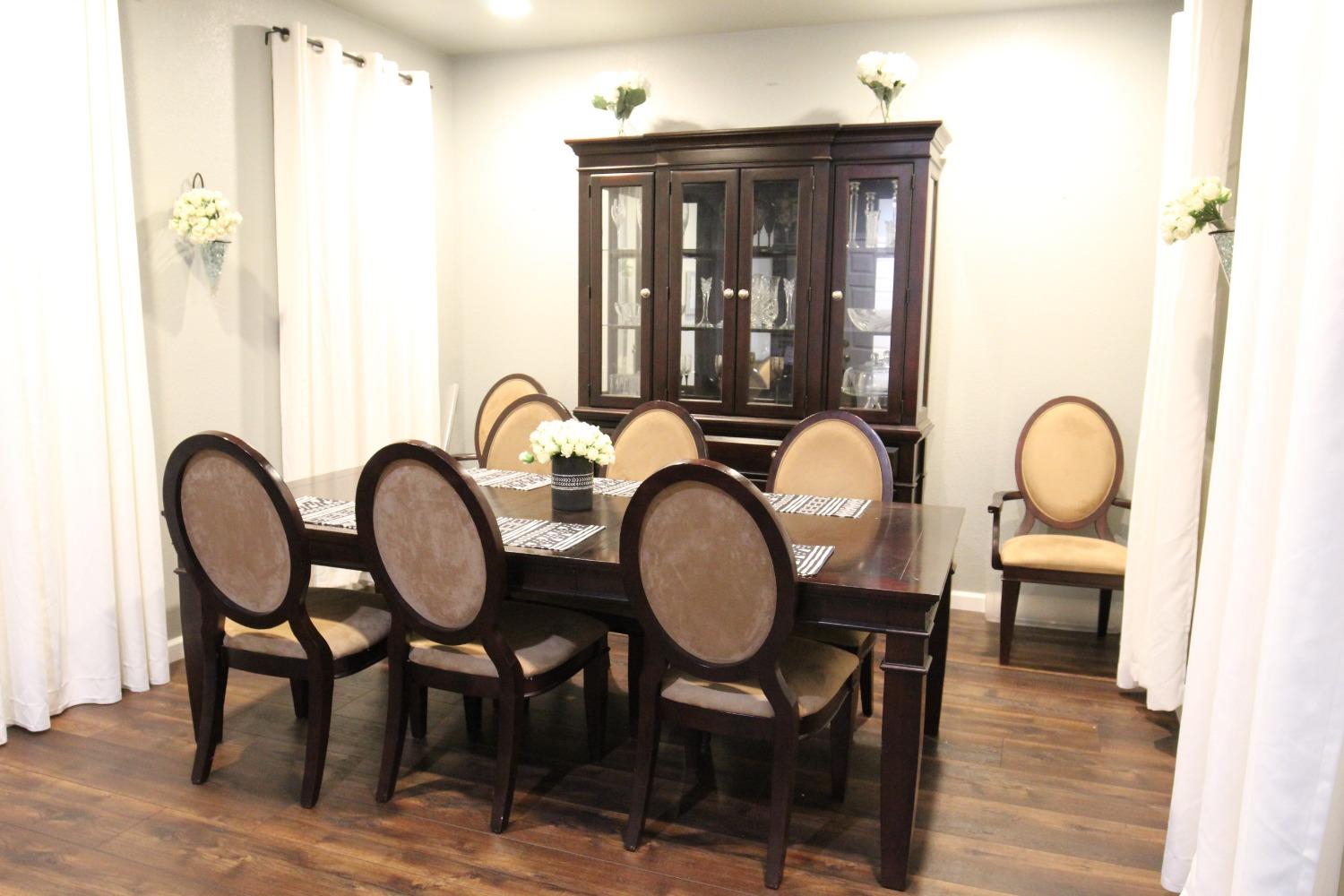 2653 Ashcroft Avenue Clovis, CA 93611 - Photo 4 of 45 a view of a dining room with furniture and wooden floor