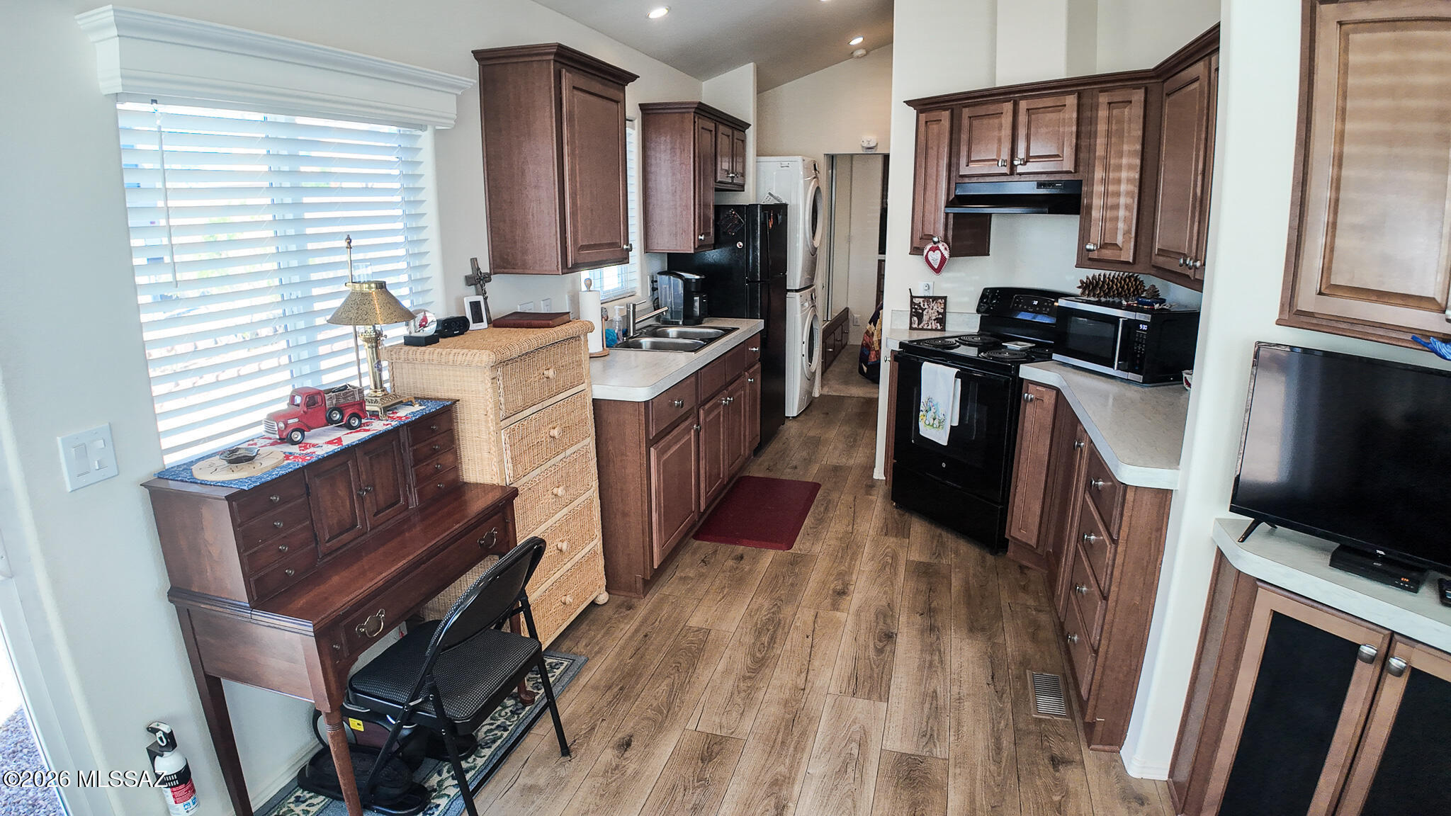 1030 Barrel Cactus Ridge, Unit 230 Benson, AZ 85602 - Photo 6 of 12 a kitchen with stainless steel appliances granite countertop a refrigerator a stove top oven a sink dishwasher and wooden cabinets