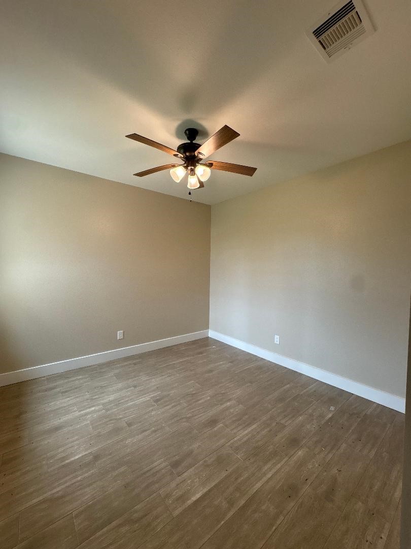5680 Essie Lane Beaumont, TX 77713 - Photo 13 of 22 a view of an empty room with a chandelier fan