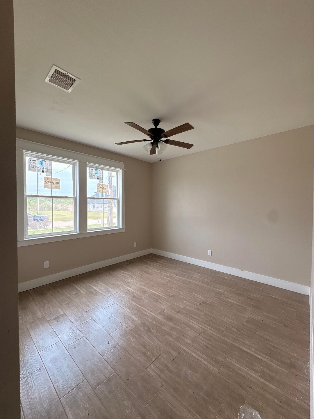 5680 Essie Lane Beaumont, TX 77713 - Photo 14 of 22 an empty room with wooden floor fan and windows