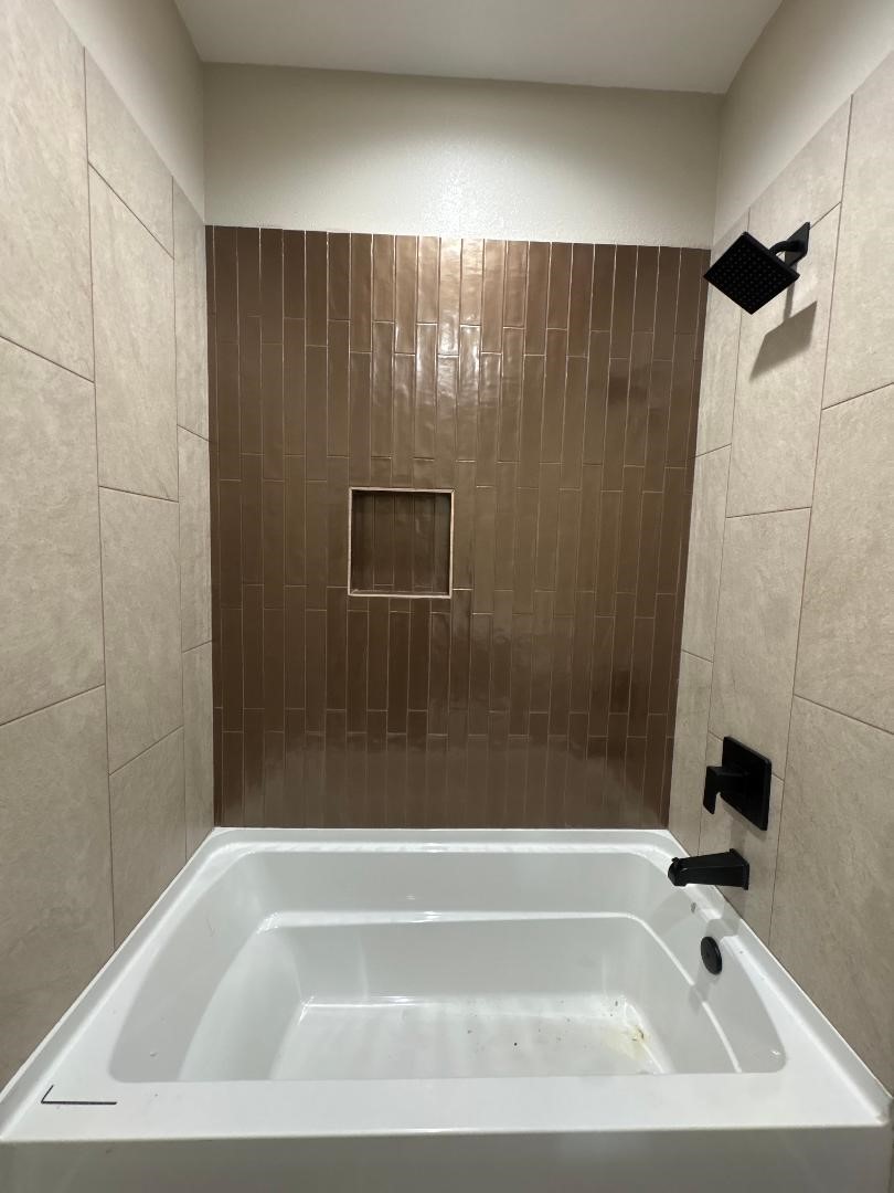 5680 Essie Lane Beaumont, TX 77713 - Photo 21 of 22 a bathroom with a shower and a bathtub