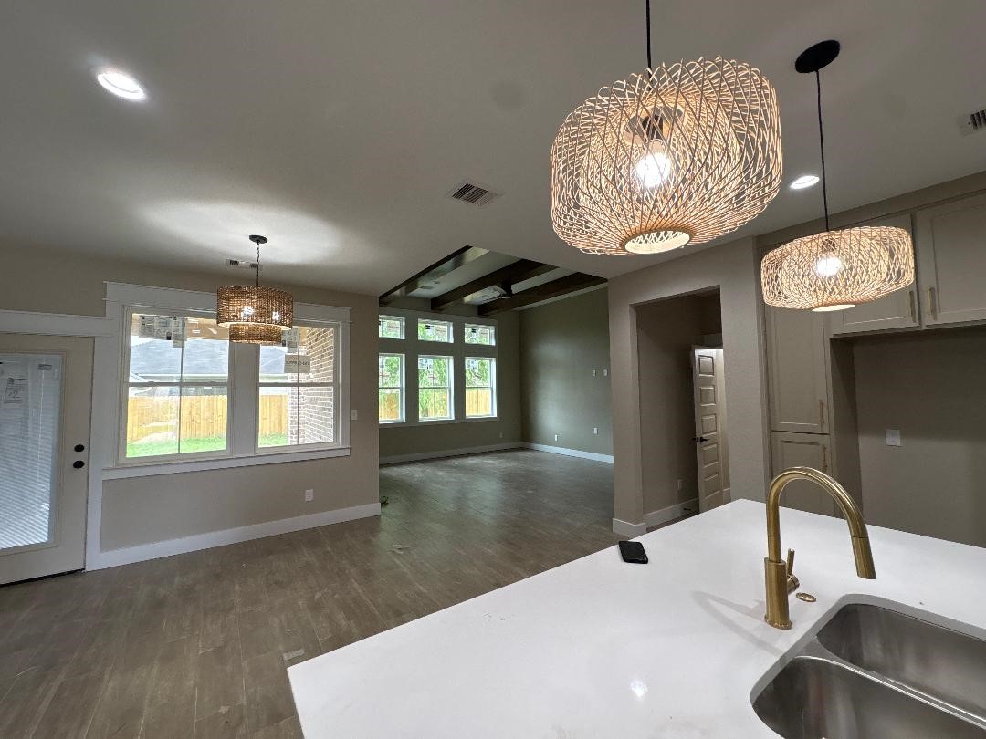5680 Essie Lane Beaumont, TX 77713 - Photo 4 of 22 a room with a chandelier and wooden floor