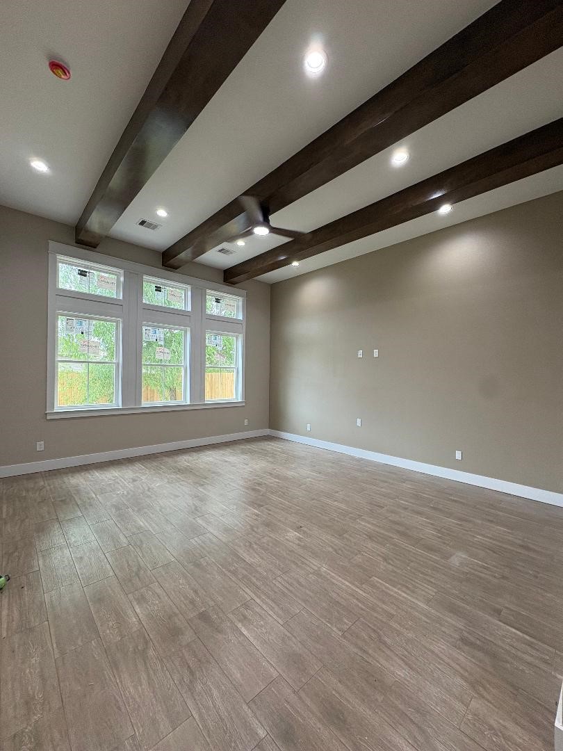 5680 Essie Lane Beaumont, TX 77713 - Photo 5 of 22 an empty room with wooden floor and windows