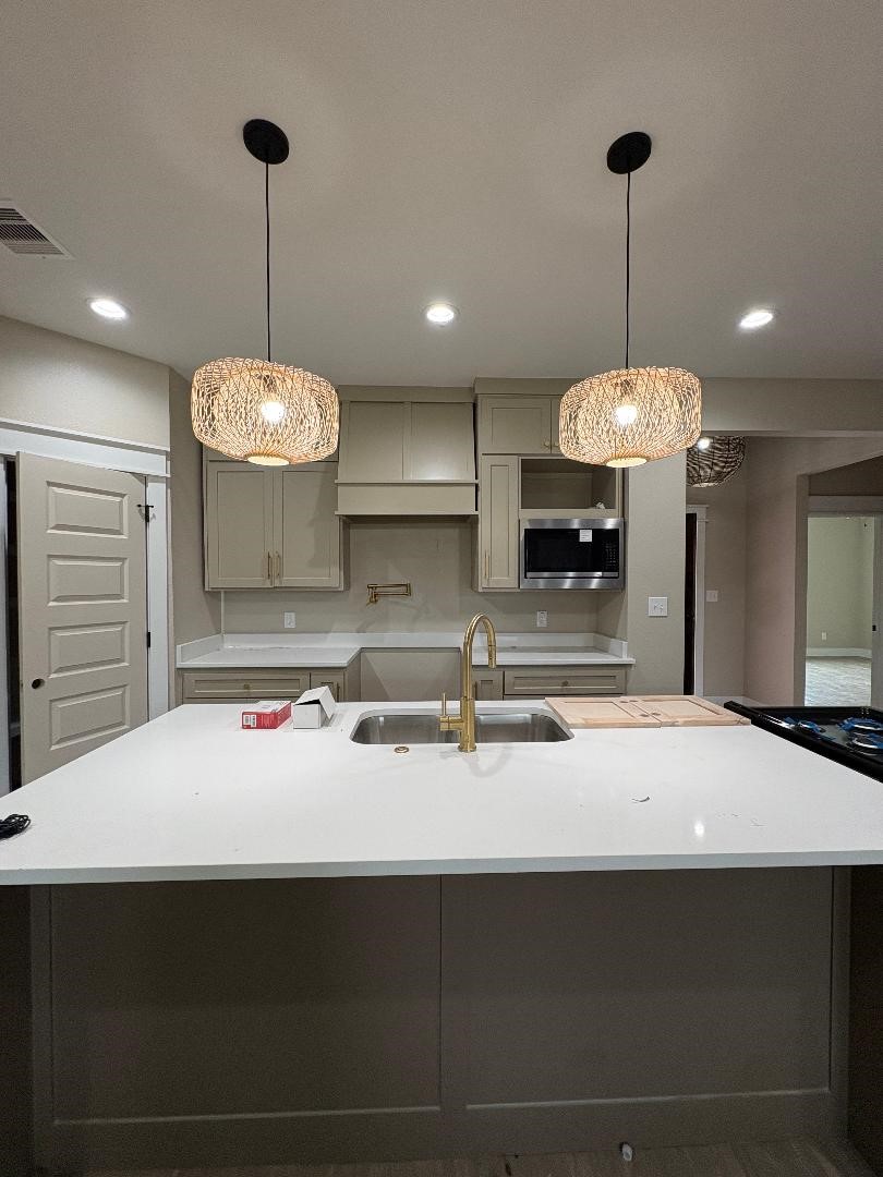 5680 Essie Lane Beaumont, TX 77713 - Photo 9 of 22 a kitchen with a counter space a sink and cabinets