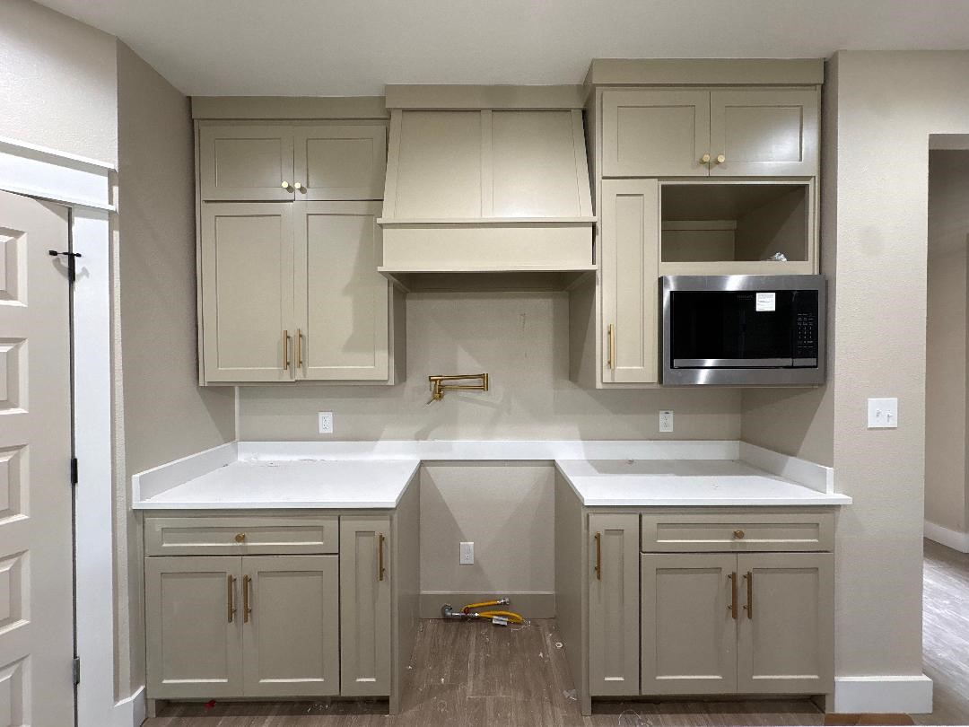 5680 Essie Lane Beaumont, TX 77713 - Photo 10 of 22 a kitchen with white cabinets and a sink