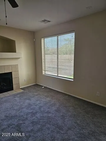 a view of a big room with an empty space and a window