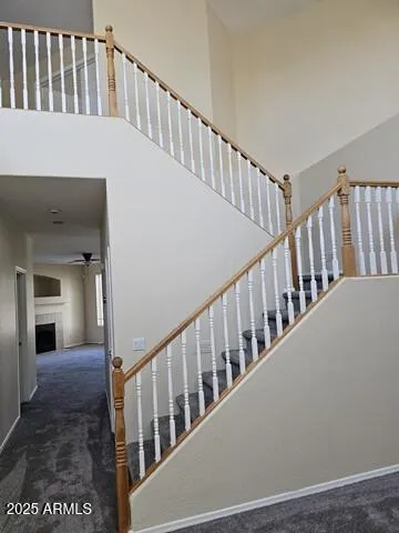 a view of staircase with railing and a window