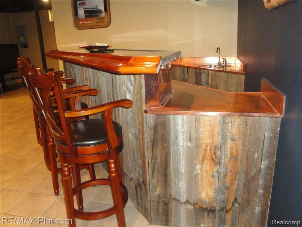1201 Oakcrest Road Howell, MI 48843 - Photo 43 of 57 The barn wood gives an awesome look to the bar. The copper top is gorgeous!