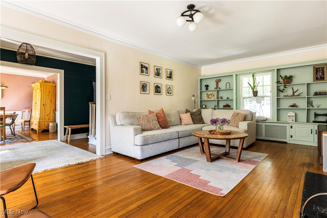 2671 Haddam Road Cleveland, OH 44120 - Photo 6 of 34 Living room featuring crown molding, dark wood-style flooring, and radiator heating unit