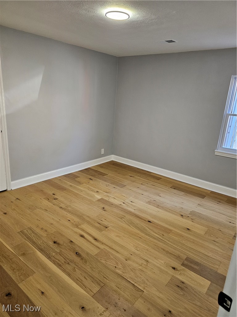 3999 Lancaster Road South Euclid, OH 44121 - Photo 4 of 17 Empty room featuring light hardwood / wood-style flooring and a textured ceiling