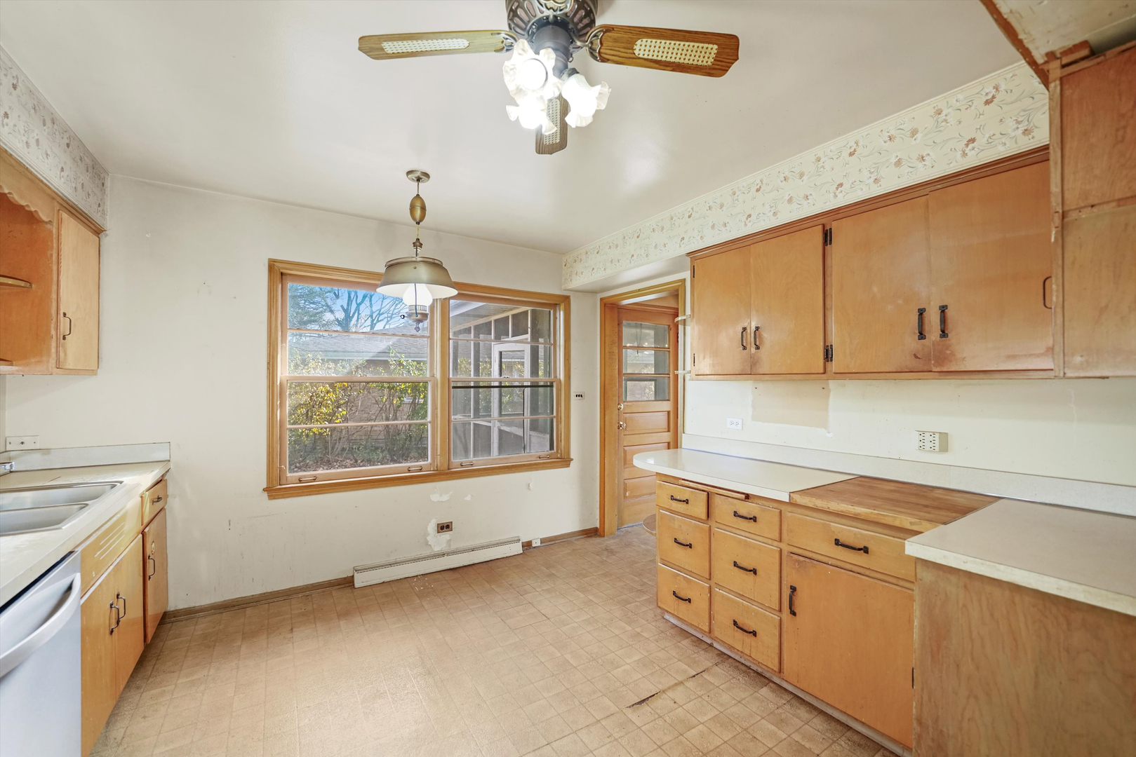 1725 North Happ Road Northbrook, IL 60062 - Photo 11 of 33 a kitchen with cabinets a sink a stove and a window