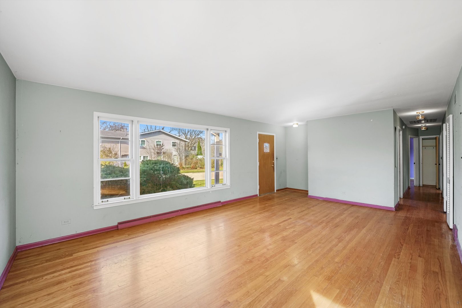 1725 North Happ Road Northbrook, IL 60062 - Photo 7 of 33 a view of an empty room with a window and wooden floor