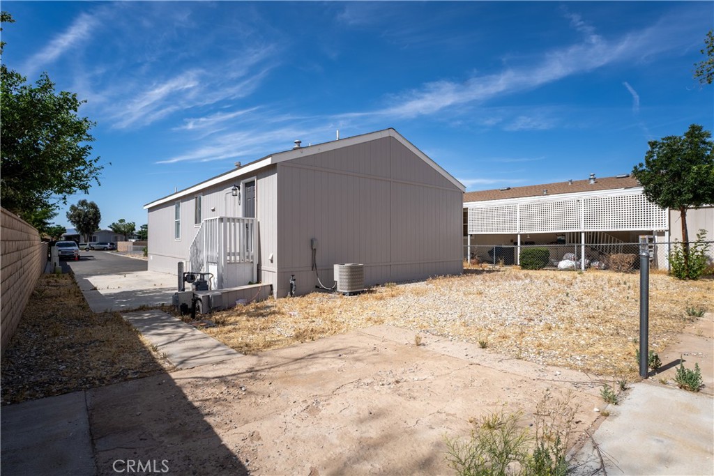 20843 Waalew Road, Unit C125 Apple Valley, CA 92307 - Photo 22 of 38 a front view of a house with a yard