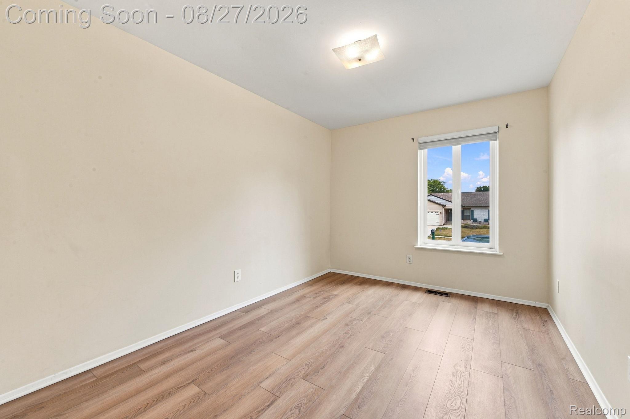 42120 Ridge Road West Novi, MI 48375 - Photo 25 of 32 Wood-finish flooring with a ceiling-mounted light fixture, and a single window