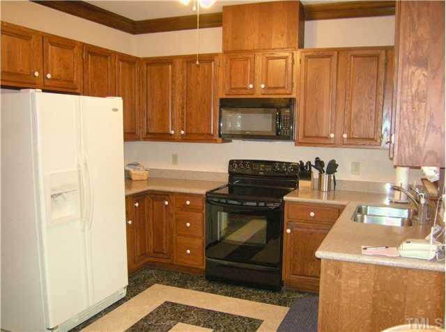 135 Skylark Way Raleigh, NC 27615 - Photo 5 of 14 Eat in kitchen offers LOTS of cabinet space. New countertops. Newer smooth top stove and built in microwave. Enjoy the outdoors from the window over the sink or sitting at the breakfast table in the bay window.