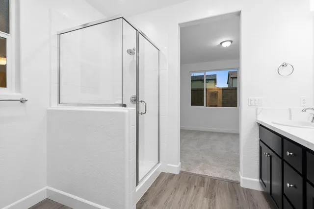 a view of bathroom with a shower and a sink