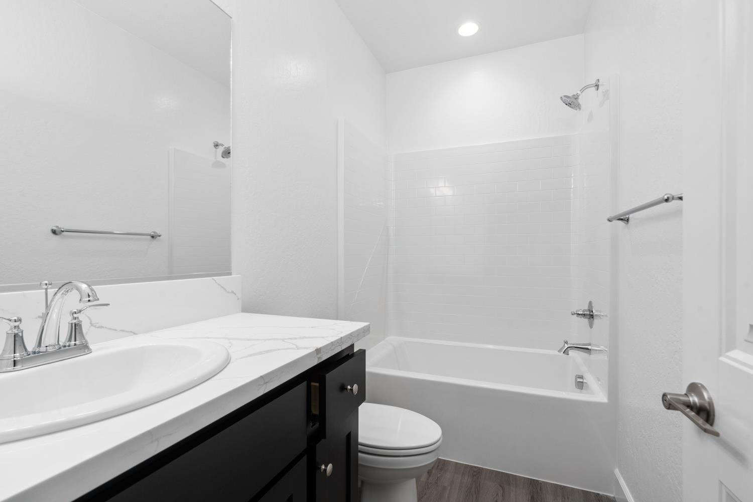 380 South Huckleberry Road Madera, CA 93636 - Photo 12 of 15 a bathroom with a sink a toilet and shower