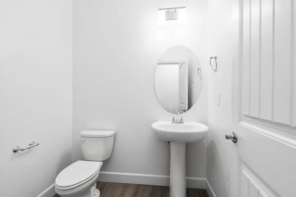 a bathroom with a sink toilet and a mirror