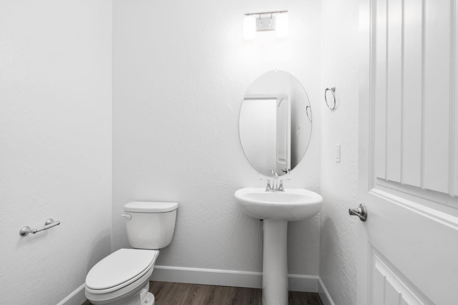 380 South Huckleberry Road Madera, CA 93636 - Photo 8 of 15 a bathroom with a sink toilet and a mirror
