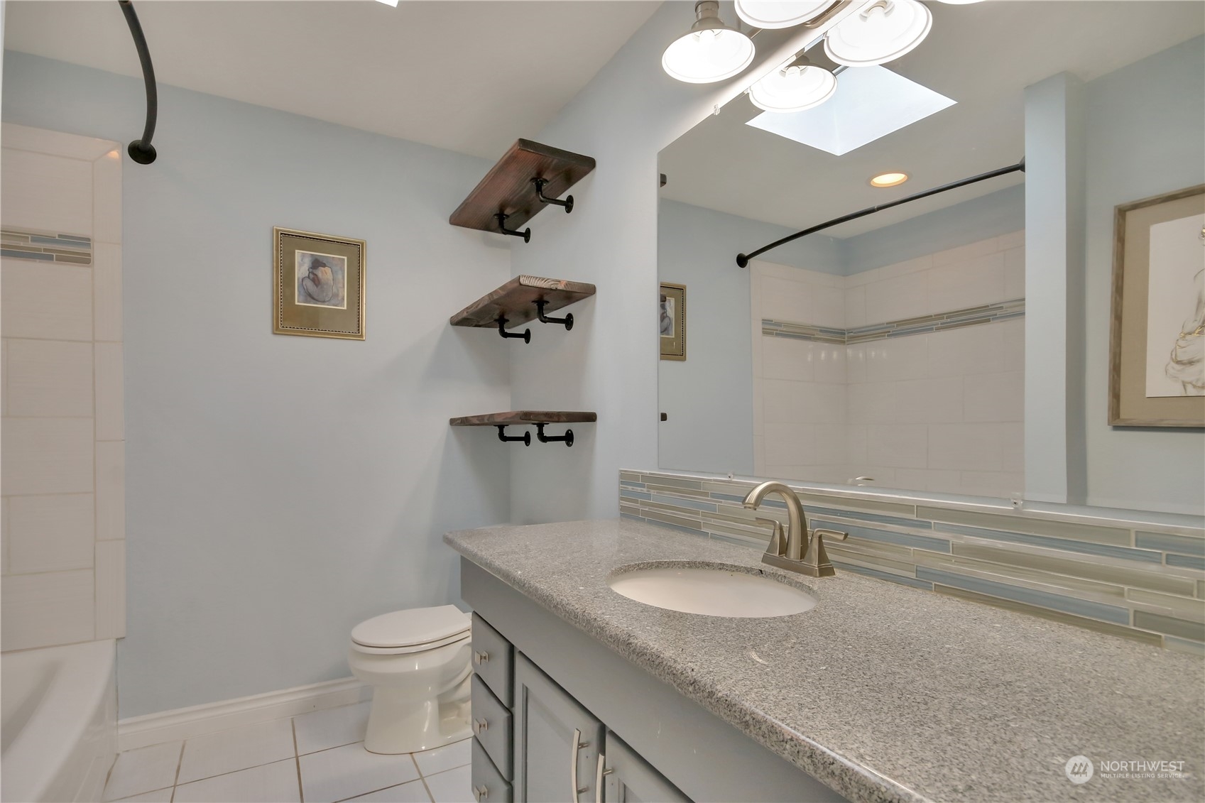 5210 Parker Road East Sumner, WA 98390 - Photo 15 of 25 a bathroom with a granite countertop sink a toilet and a mirror