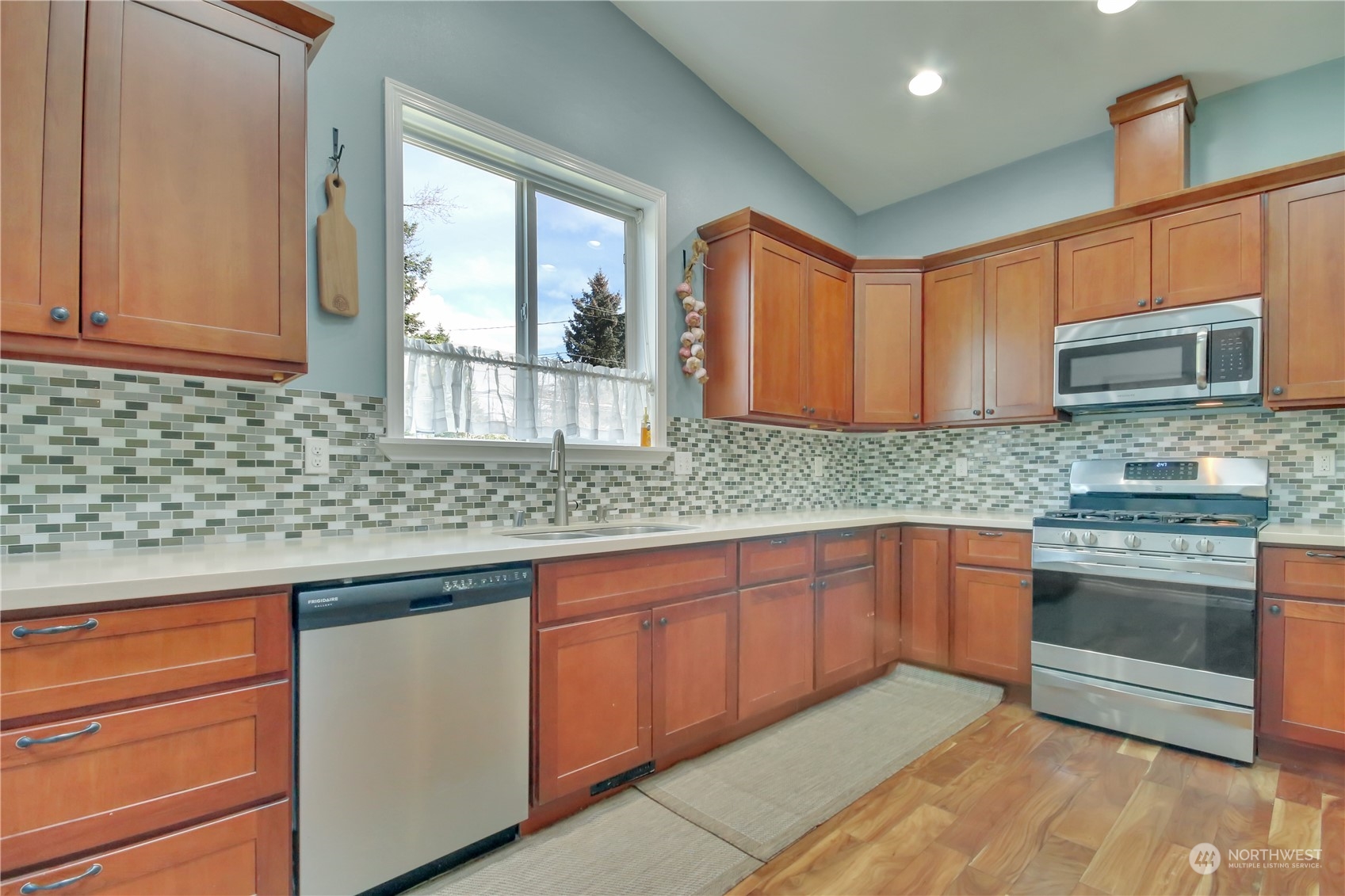 5210 Parker Road East Sumner, WA 98390 - Photo 7 of 25 a kitchen with stainless steel appliances granite countertop wooden cabinets a sink and a stove