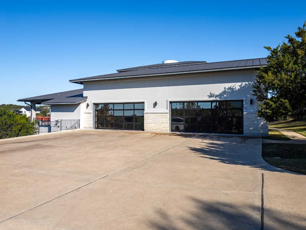 14900 Copper Ridge Lane Austin, TX 78734 - Photo 2 of 39 a front view of a house with a yard and a garage