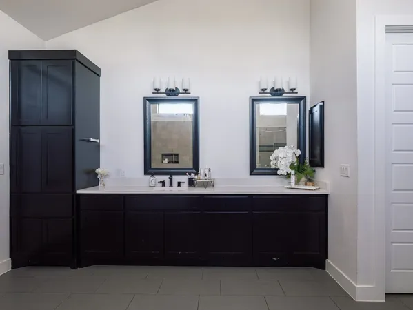 a bathroom with a double vanity sink and a mirror