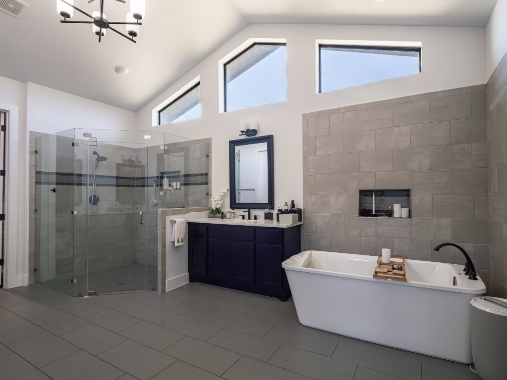 14900 Copper Ridge Lane Austin, TX 78734 - Photo 22 of 39 a bathroom with a tub a sink and mirror
