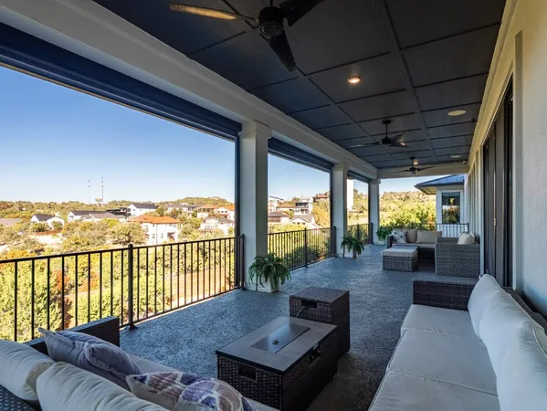 a balcony with furniture and a floor to ceiling window
